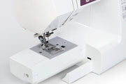 Janome 2030DC-G computerized sewing machine in grapevine purple front profile view showing the control dashboard.