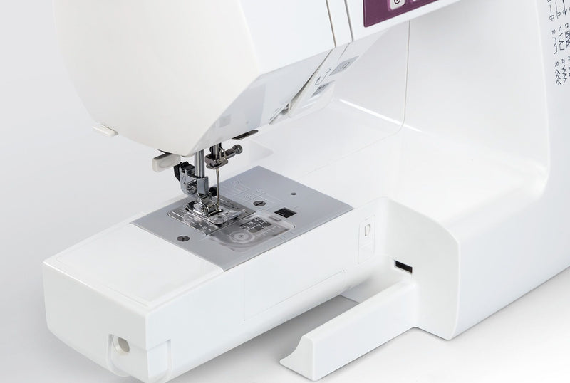 Janome 2030DC-G computerized sewing machine in grapevine purple front profile view showing the control dashboard.