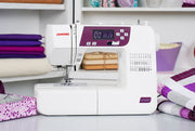 Janome 2030DC-G computerized sewing machine in grapevine purple front profile view showing the control dashboard.