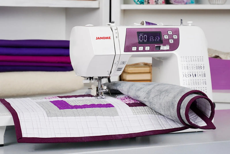 Janome 3160QDC-G computerized sewing and quilting machine in grapevine purple front view displaying the navigation layout.