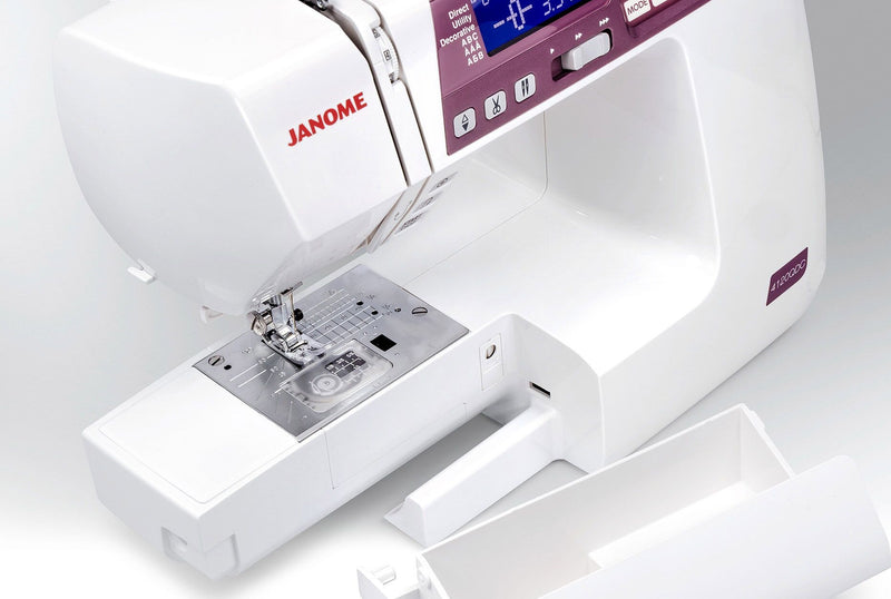 Janome 4120QDC-G computerized sewing and quilting machine in grapevine purple front view displaying the stitch index chart