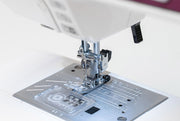 Janome 4120QDC-G computerized sewing and quilting machine in grapevine purple front view displaying the stitch index chart
