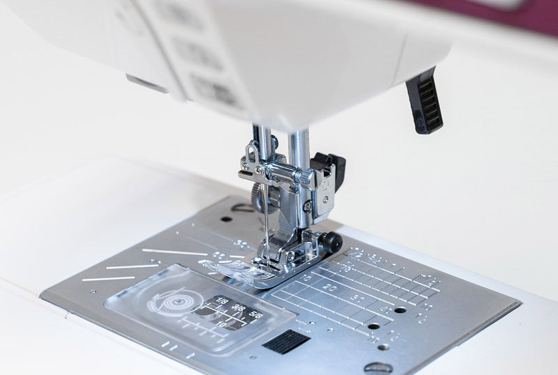 Janome 4120QDC-G computerized sewing and quilting machine in grapevine purple front view displaying the stitch index chart