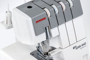 Janome MyLock 454D overlock serger front view showing the color-coded threading map and tension dials.