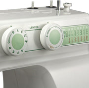 Janome 2212 mechanical sewing machine front view showcasing the stitch selection dial and clean white design.