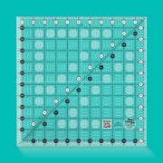 Creative Grids CGR11 eleven and a half inch square quilt ruler showing clear grid lines.