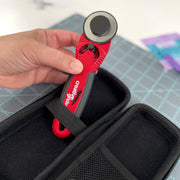 Creative Grids CGRCUT45 45mm ergonomic rotary cutter standing next to its black hard zippered EVA protective case.