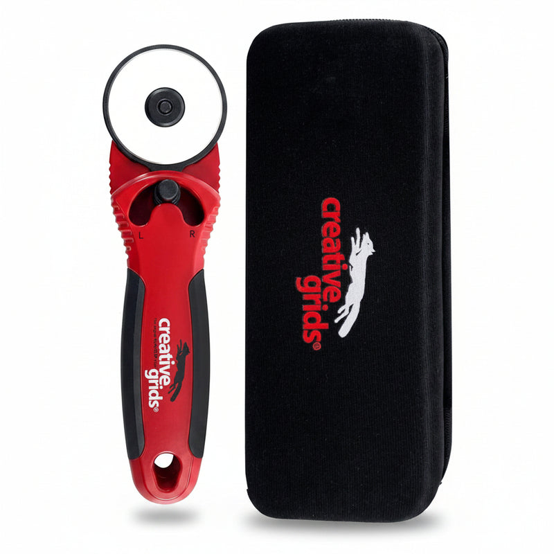 Creative Grids CGRCUT45 45mm ergonomic rotary cutter standing next to its black hard zippered EVA protective case.