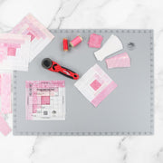 Creative Grids 18 inch by 24 inch grid free self healing rotary cutting mat CGRMATB1824 flat workspace view.