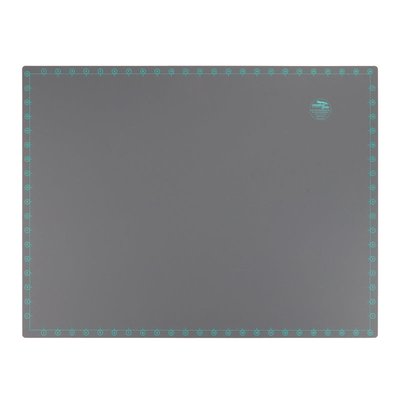 Creative Grids 18 inch by 24 inch grid free self healing rotary cutting mat CGRMATB1824 flat workspace view.