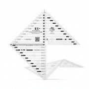Creative Grids 6-inch flying geese and 45/90 degree triangle quilting ruler laid over light fabric showing black and white lines.