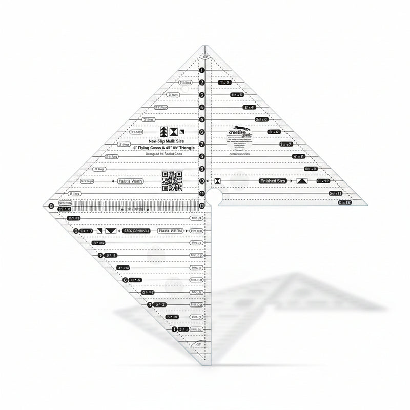 Creative Grids 6-inch flying geese and 45/90 degree triangle quilting ruler laid over light fabric showing black and white lines.