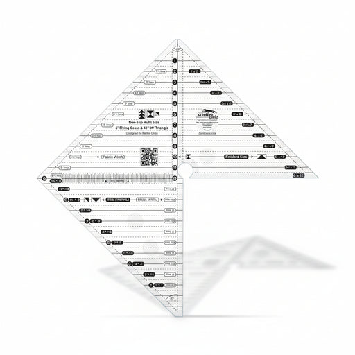 Creative Grids 6-inch flying geese and 45/90 degree triangle quilting ruler laid over light fabric showing black and white lines.