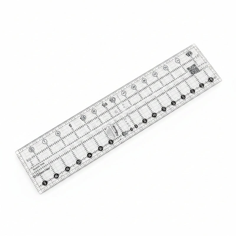 Creative Grids Quick Trim 3.5-inch by 12.5-inch rectangle quilting ruler laid flat over patterned fabric.