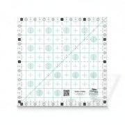 Creative Grids Perfect 10 square quilting ruler placed perfectly over a 10-inch fabric layer cake block.