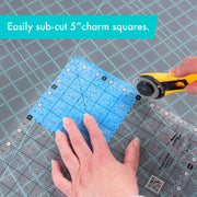 Creative Grids Perfect 10 square quilting ruler placed perfectly over a 10-inch fabric layer cake block.