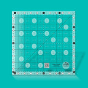 Creative Grids Perfect 10 square quilting ruler placed perfectly over a 10-inch fabric layer cake block.