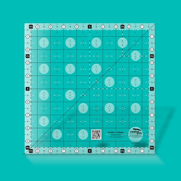Creative Grids Perfect 10 square quilting ruler placed perfectly over a 10-inch fabric layer cake block.