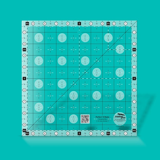 Creative Grids Perfect 10 square quilting ruler placed perfectly over a 10-inch fabric layer cake block.