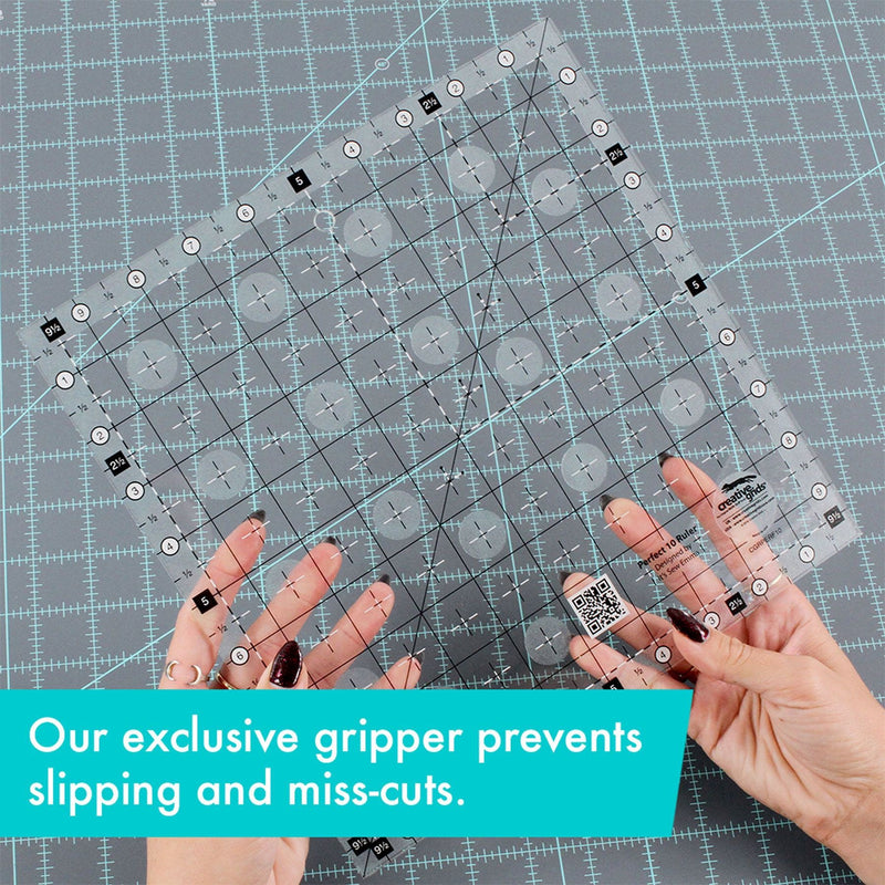 Creative Grids Perfect 10 square quilting ruler placed perfectly over a 10-inch fabric layer cake block.