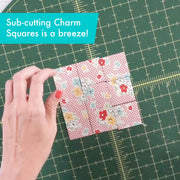 Creative Grids Perfect 5 square quilting ruler placed directly over a 5-inch fabric charm pack square.