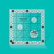 Creative Grids Perfect 5 square quilting ruler placed directly over a 5-inch fabric charm pack square.