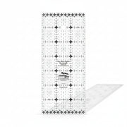 Creative Grids Itty-Bitty Eights 3-inch by 7-inch rectangle quilting ruler sitting over a miniature patchwork block.