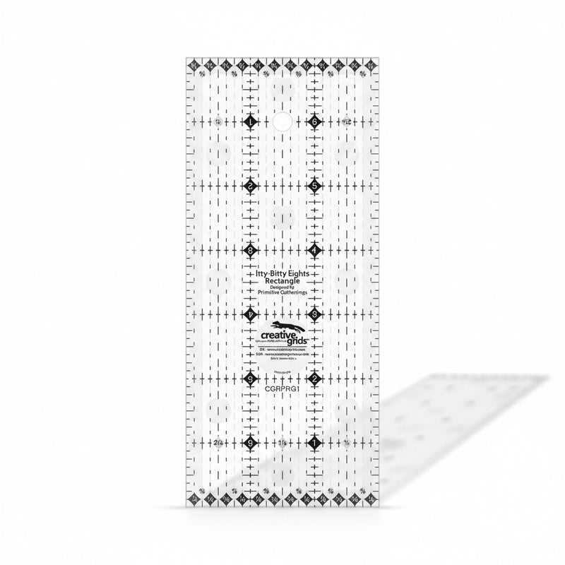 Creative Grids Itty-Bitty Eights 3-inch by 7-inch rectangle quilting ruler sitting over a miniature patchwork block.
