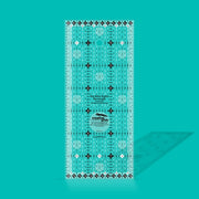 Creative Grids Itty-Bitty Eights 3-inch by 7-inch rectangle quilting ruler sitting over a miniature patchwork block.