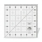 Creative Grids Itty-Bitty Eights 6-inch by 6-inch square quilting ruler sitting over a geometric patchwork block center.