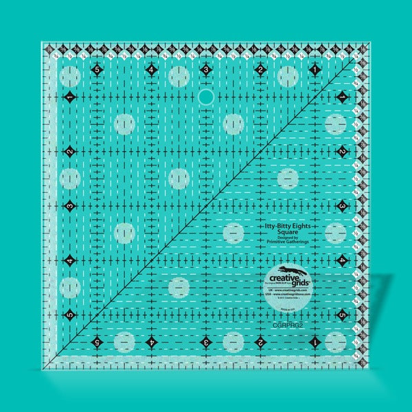 Creative Grids Itty-Bitty Eights 6-inch by 6-inch square quilting ruler sitting over a geometric patchwork block center.