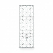 Creative Grids Charming Itty-Bitty Eights 5-inch by 15-inch rectangle quilting ruler sitting over a charm pack fabric layout.