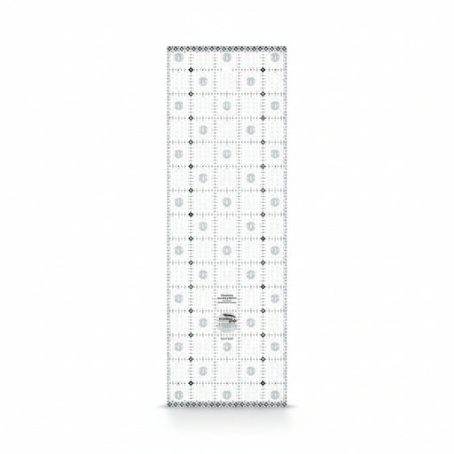 Creative Grids Charming Itty-Bitty Eights 5-inch by 15-inch rectangle quilting ruler sitting over a charm pack fabric layout.