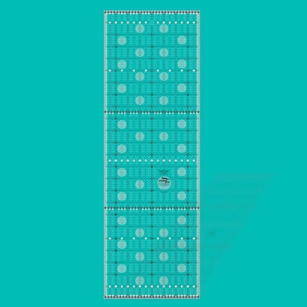Creative Grids Itty-Bitty Eights XL 8-inch by 24-inch rectangle quilting ruler positioned over a wide fabric yardage fold.
