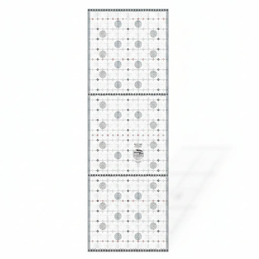 Creative Grids Itty-Bitty Eights XL 8-inch by 24-inch rectangle quilting ruler positioned over a wide fabric yardage fold.