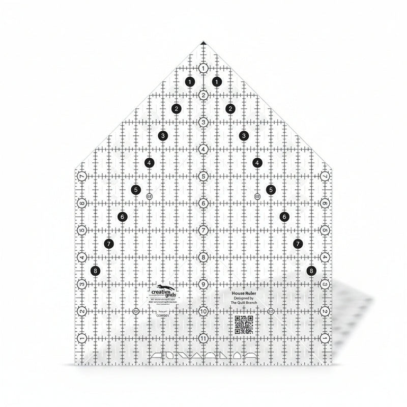 Creative Grids House Quilt Ruler placed over a freshly cut fabric house block.