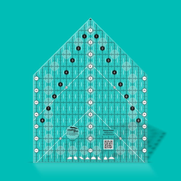 Creative Grids House Quilt Ruler placed over a freshly cut fabric house block.