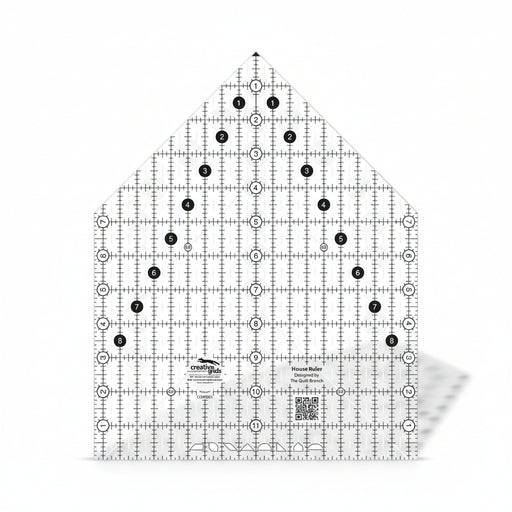 Creative Grids House Quilt Ruler placed over a freshly cut fabric house block.