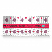 Creative Grids I Love My Quilt Friends Mini 2.5-inch by 6-inch rectangle ruler with pink accents laid over a small patchwork block.