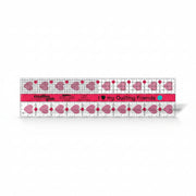 Creative Grids I Love My Quilt Friends 2.5-inch by 10-inch rectangle ruler with pink accents laid over jelly roll fabric strips.