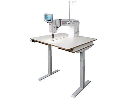 Janome Quilt Maker Pro 20 Versa ST sit-down longarm mounted into the sturdy manually adjustable Regulated Table.