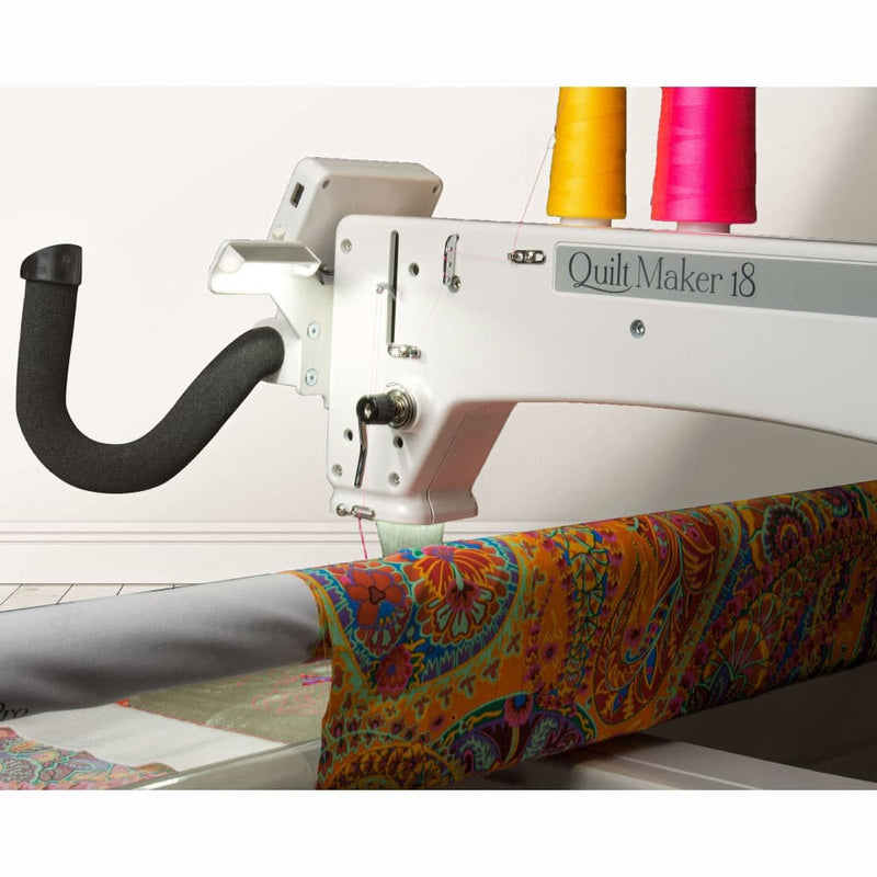 Janome Quilt Maker 18 longarm quilting machine head highlighting the ergonomic handles and LCD touchscreen display.