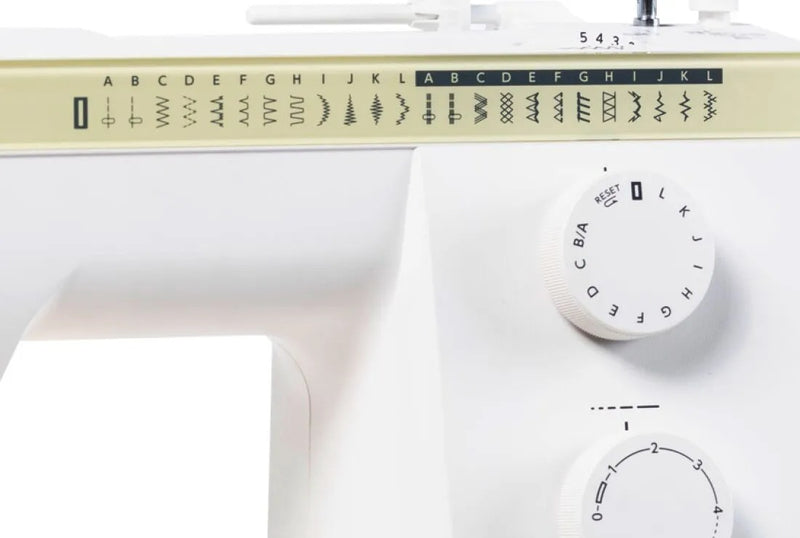 Janome Sewist 725 mechanical sewing machine front view showcasing stitch pattern selection dials and layout lines.