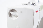 Janome Sewist 725 mechanical sewing machine front view showcasing stitch pattern selection dials and layout lines.