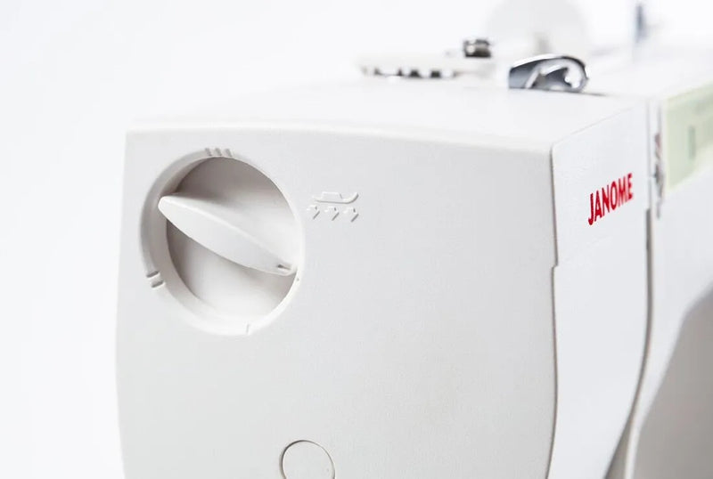 Janome Sewist 725 mechanical sewing machine front view showcasing stitch pattern selection dials and layout lines.