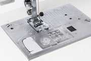Janome 4120QDC-G computerized sewing and quilting machine in grapevine purple front view displaying the stitch index chart