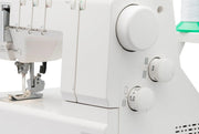 Janome 2000CPX cover hem sewing machine front view showing the color reference chart and extra-long bed