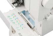 Janome 2000CPX cover hem sewing machine front view showing the color reference chart and extra-long bed