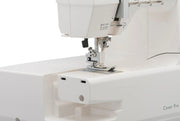 Janome 2000CPX cover hem sewing machine front view showing the color reference chart and extra-long bed
