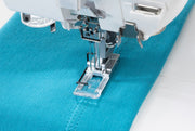 Janome CoverPro 3000P professional cover hem machine front view showing the extra long bed and thread cones.